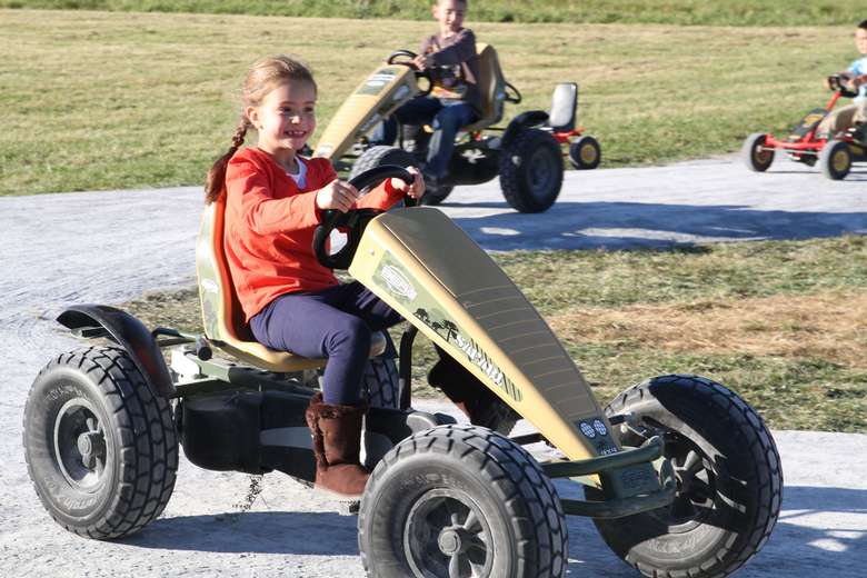 kids riding motorized four-wheel vehicles
