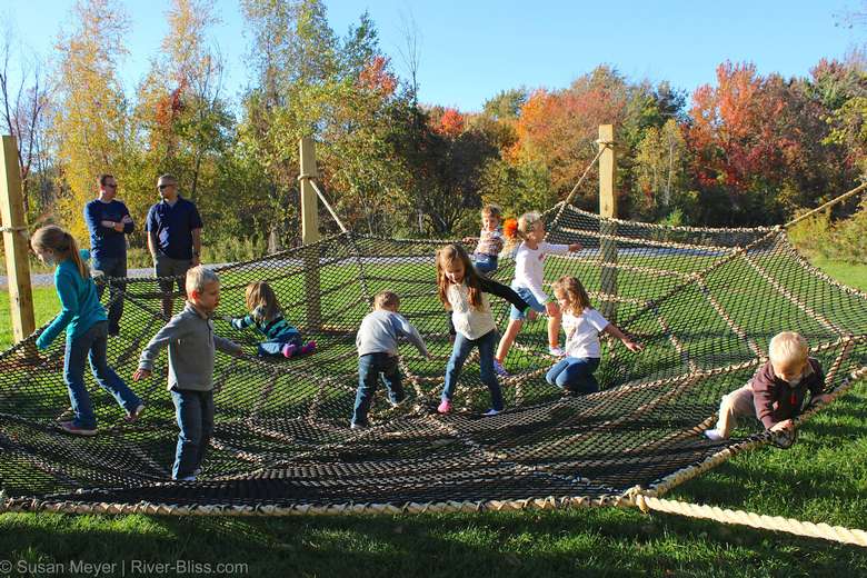 kids playing in a rope spiders web